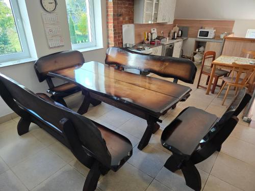 a dining room with a wooden table and chairs at KWT Hostel Nowogard - Self Check-In - Wejscie na KOD in Nowogard