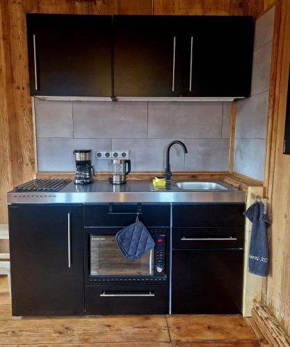a kitchen with a sink and a stove at Faktorei 312 in Eibau