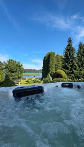 a pool of water with trees and a lake at Ruciane Residence in Ruciane-Nida