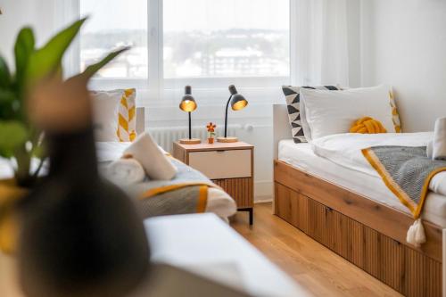 a bedroom with two beds and a window at BASEKAMP Horizon I Luzern I Familie I Pilatus in Lucerne