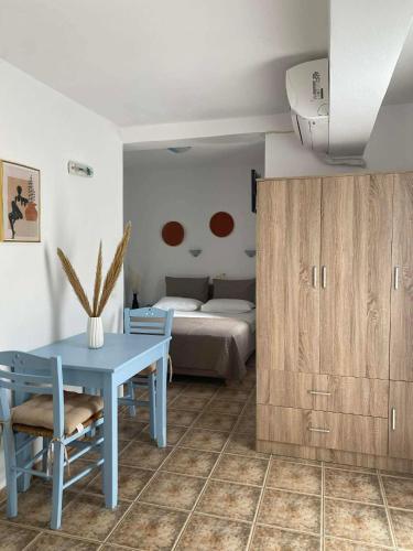 a bedroom with a blue table and a bed at 9 Muses in Elafonisos