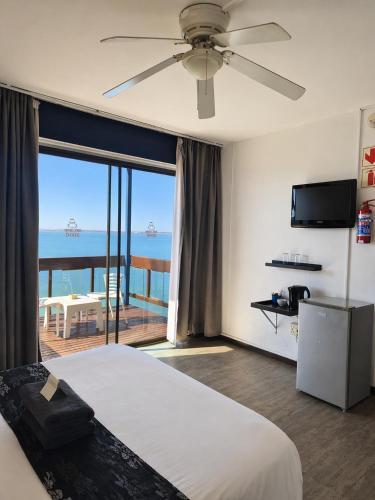 a bedroom with a bed and a view of the ocean at Hoedjiesbaai Hotel in Saldanha