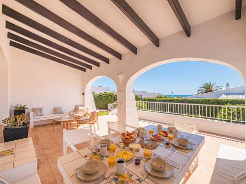 a dining room with a table with food on it at Villa BiniRe by 3VILLAS in Binibeca