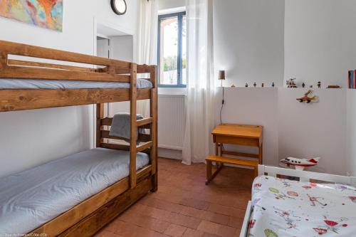 a bedroom with two bunk beds and a table at Le Clos des Erables in Dijon
