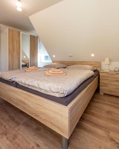 a bedroom with a large wooden bed with wooden floors at Ferienwohnung Tietze in Fockendorf