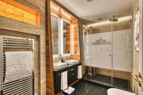 a bathroom with a sink and a shower at Hotel Schweizerhof Luzern in Lucerne