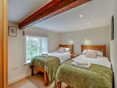 a bedroom with two beds and a window at 4 Bed in Richmond oc-g0083 in Feetham