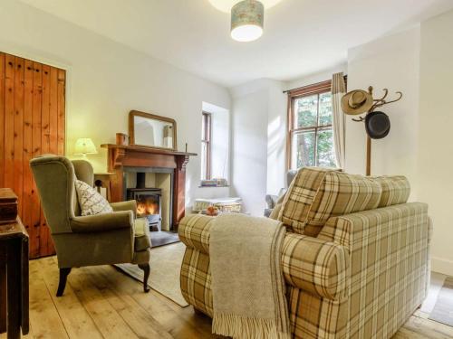 a living room with a couch and a chair and a fireplace at 2 Bed in Cupar oc-78228 in Ceres