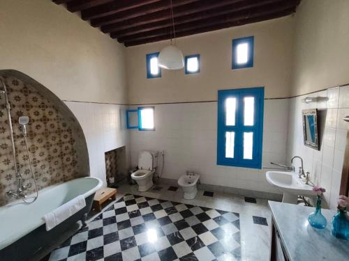 a bathroom with a tub and a toilet and a sink at Boutique Hotel Beit el Nessim in El Mîna