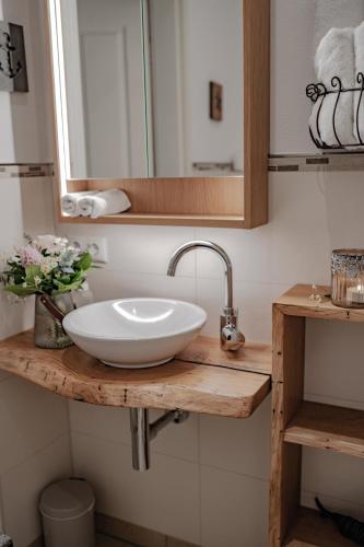 a bathroom with a white sink and a mirror at Landgut zur Mühle in Dorfen