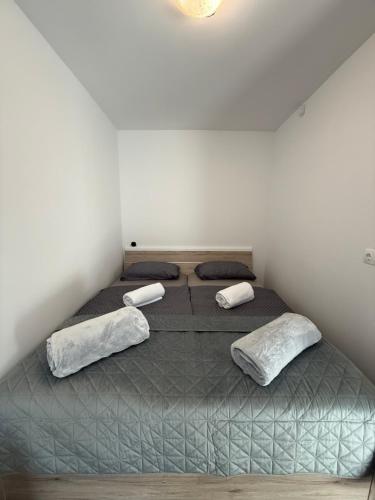 a bedroom with a large bed with two pillows at ILK Residence 1 in Alsóörs