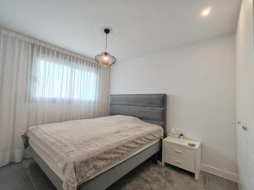 a bedroom with a bed and a window at Vitta Nature Spa - 3 bedrooms in Mijas Costa