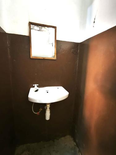 a bathroom with a white sink and a mirror at HOTSPOT inn - Malindi in Malindi