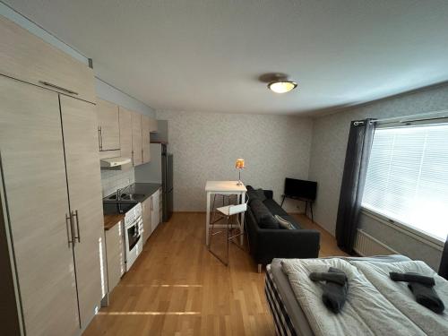 a small living room with a couch and a kitchen at Klintvägen 18 E 31 in Mariehamn