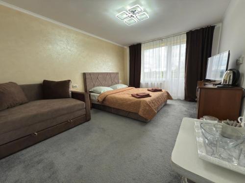 a hotel room with a bed and a couch at Квітуча Гора Double Room in Lazeshchyna