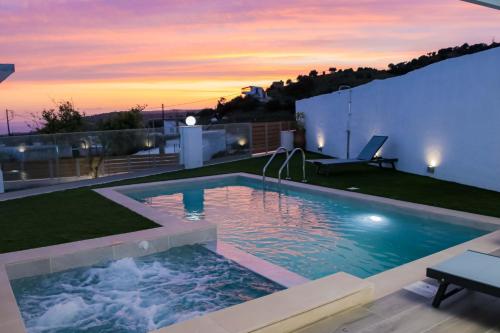 a swimming pool on the roof of a house at Thea Villa in Kokkinos Pirgos