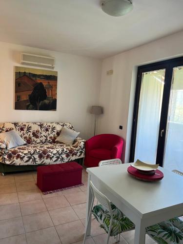 a living room with a couch and a table at Dimora Dafne in Policoro