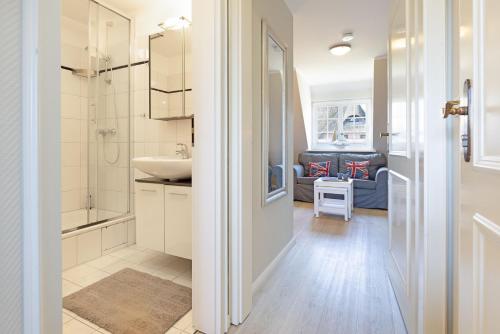 a bathroom with a sink and a shower and a toilet at Auster Holte Hüüs in List