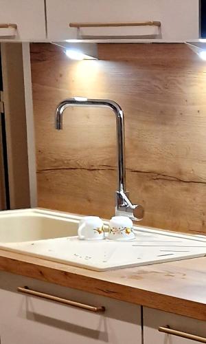 a bathroom sink with a faucet next to a bath tub at A La Bruyère in Saint-Martin-du-Lac