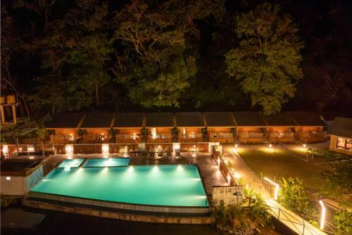 an image of a pool at night at Dandeli Kali Resort in Dandeli