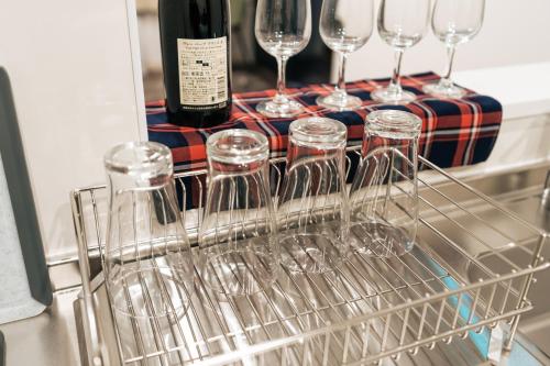 a group of wine glasses sitting in a dish rack at T-square旭大前I in Asahikawa