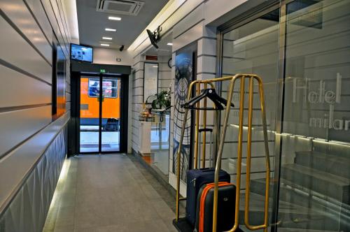 a hallway with a suitcase in front of a store at Hotel Rio in Milan