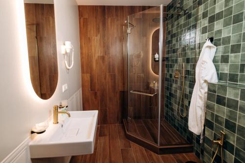 a bathroom with a sink and a shower at Gasthaus & Spa Bukovel in Bukovel
