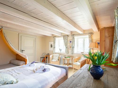 a bedroom with a large bed and a table at Haus Quitte in Kühlungsborn