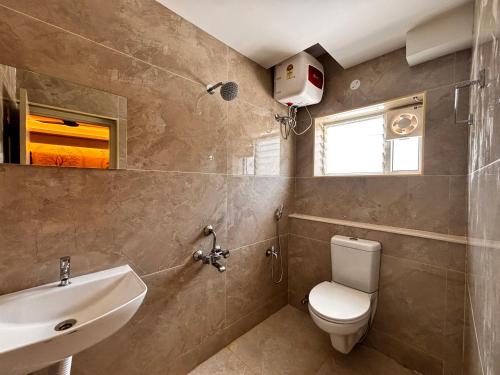 a bathroom with a toilet and a sink at ADITI ROOMS in Tiruchirappalli