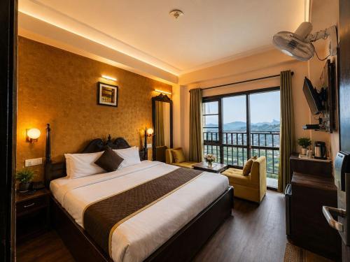 a hotel room with a large bed and a balcony at Hotel Aachman Regency with Rooftop Terrace in Shimla