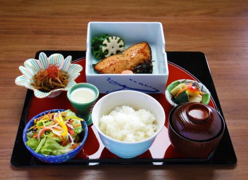 a tray of food with sushi and rice on a table at APA Hotel Woodbridge in Iselin