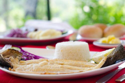 a white plate of food on a red table at Hotel Salto Del Laja in Los Ángeles