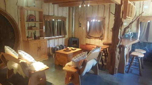a living room with chairs and a table in a house at Vientos de Chauquen in Panguipulli