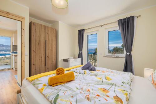a bedroom with a bed with a teddy bear on it at Seaview apartments Refugium Krk in Polje