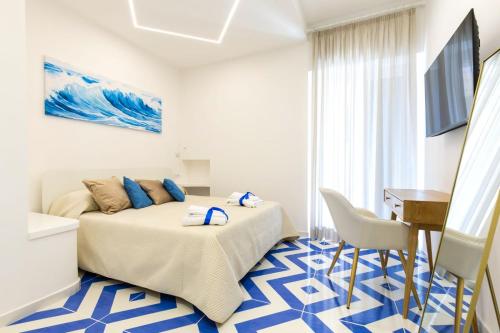 a bedroom with a bed and a table and a desk at Isabel Luxury Suite in Ischia