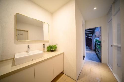 a bathroom with a sink and a mirror at 九份觀海樓民宿 in Jiufen