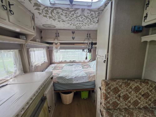 an interior view of an rv with a bed at Bed and Breakfast Reestdal in Meppel