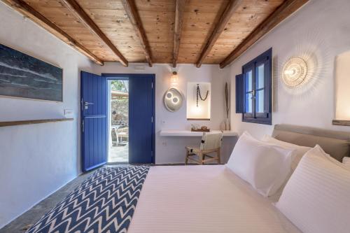 a bedroom with a bed and a desk at Marketos Windmill House in Tripiti