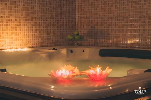 two candles in a bath tub in a bathroom at Tolip Hotel Alexandria in Alexandria