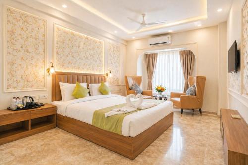 a hotel room with a bed and a chair at Solenne Retreat in Bodh Gaya