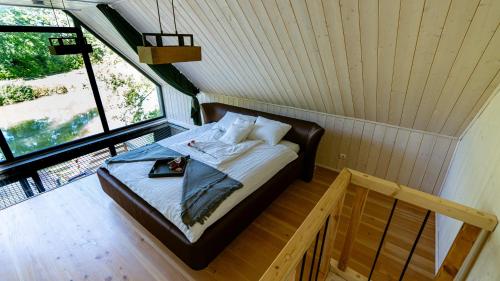 a bed in a room with a window at Leśne Szepty Resort in Zebrzydów