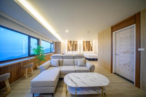 a living room with a couch and a table at 九份觀海樓民宿 in Jiufen