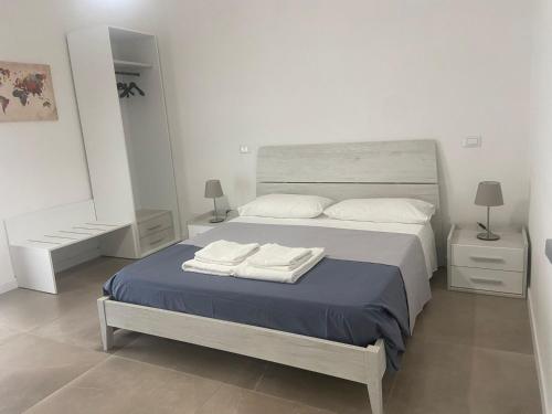 a bedroom with a bed with two towels on it at B&B Sparta in Crotone