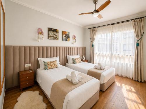 a bedroom with two beds and a window at Marina Executive Suites in Agadir