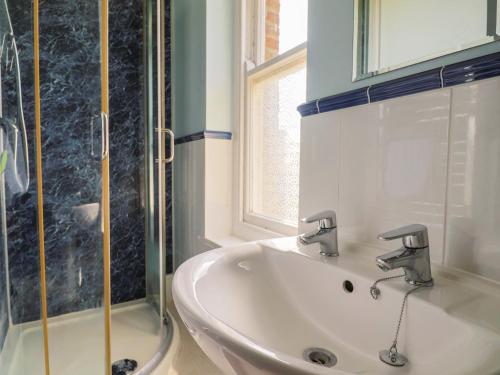 a bathroom with a sink and a shower at Gould's Farmhouse in Blandford Forum