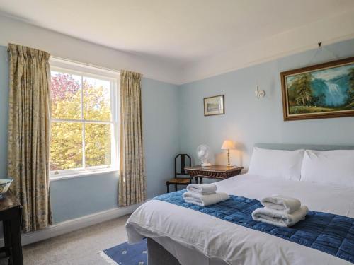 a bedroom with a bed with towels on it at Gould's Farmhouse in Blandford Forum