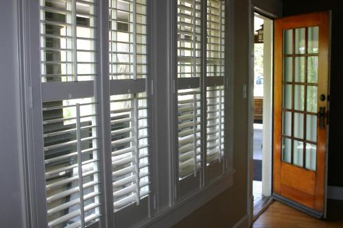 a room with plantation shutters on a door at Showers Inn in Bloomington