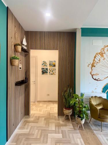 a room with a hallway with a door and plants at Da Delfina Affittacamere in Anzio