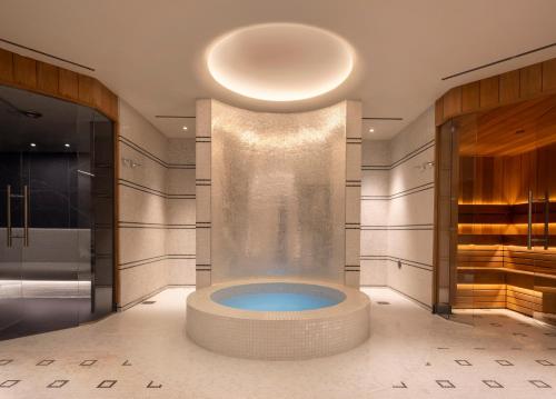 a bathroom with a tub in the middle of a room at The Beaumont Mayfair in London
