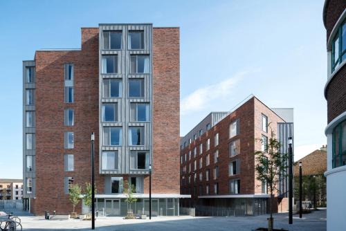 a rendering of a tall red brick building at Binary Hub - Aparto in Dublin